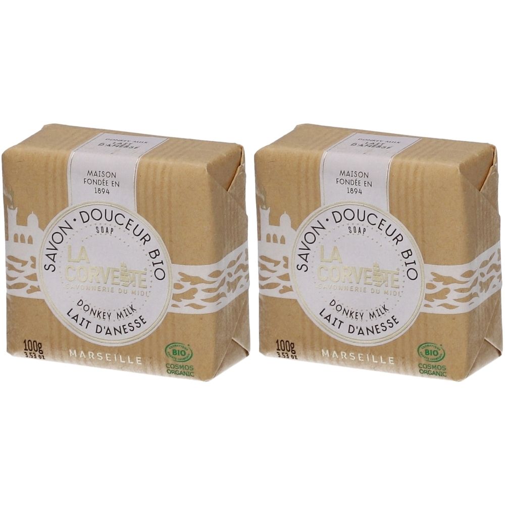 Deux savons emballés dans du papier. Inscription: Savon Douceur Bio, Lait d'Anesse, 100g, Marseille. Certification bio.
