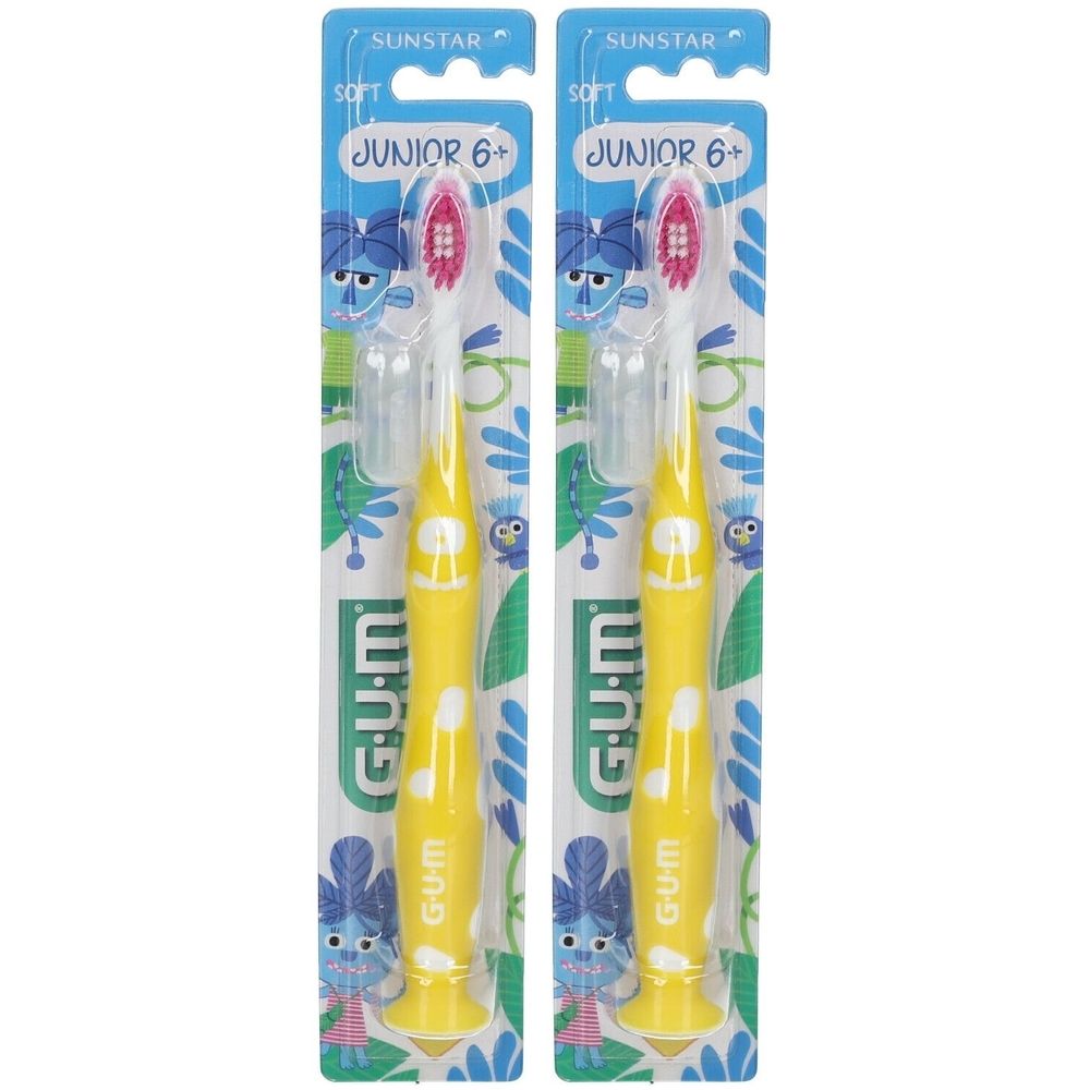 Deux brosses à dents jaunes pour enfants, emballées. Inscriptions : GUM, Junior 6+. Soies roses. Emballage avec motif bleu.