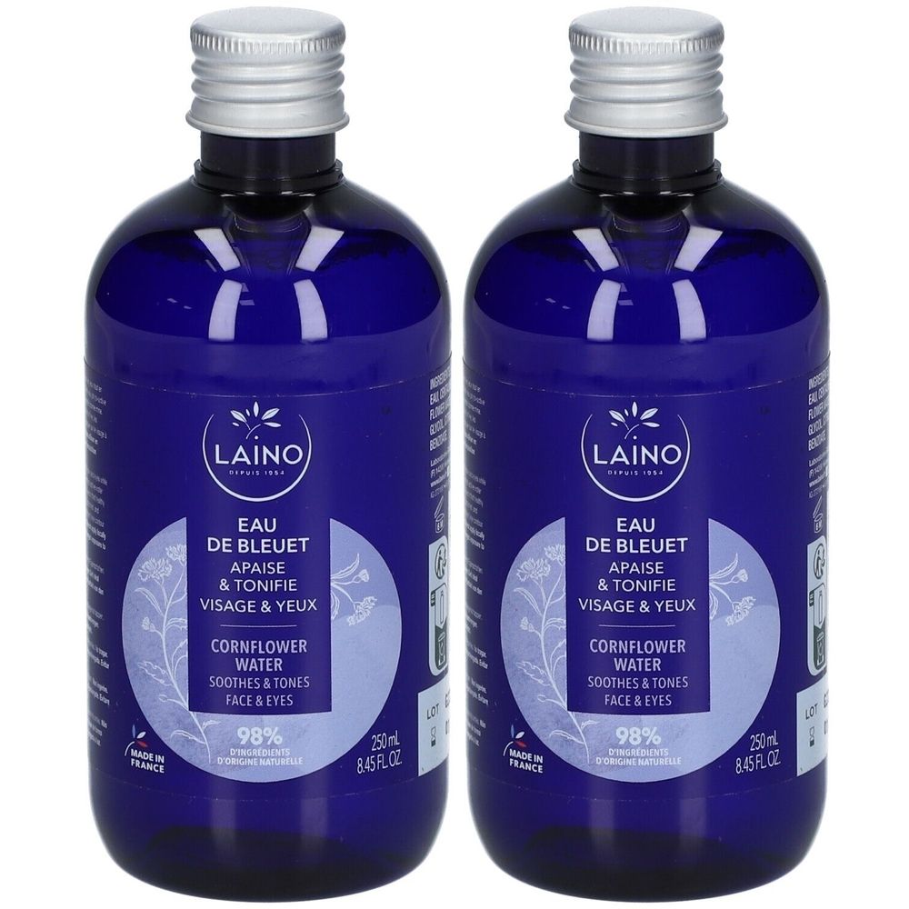 Zwei blaue Flaschen mit silbernen Deckeln. Auf den Etiketten steht "LAINO Eau de Bleuet". Text: "Apais & Tonifie Visage & Yeux".