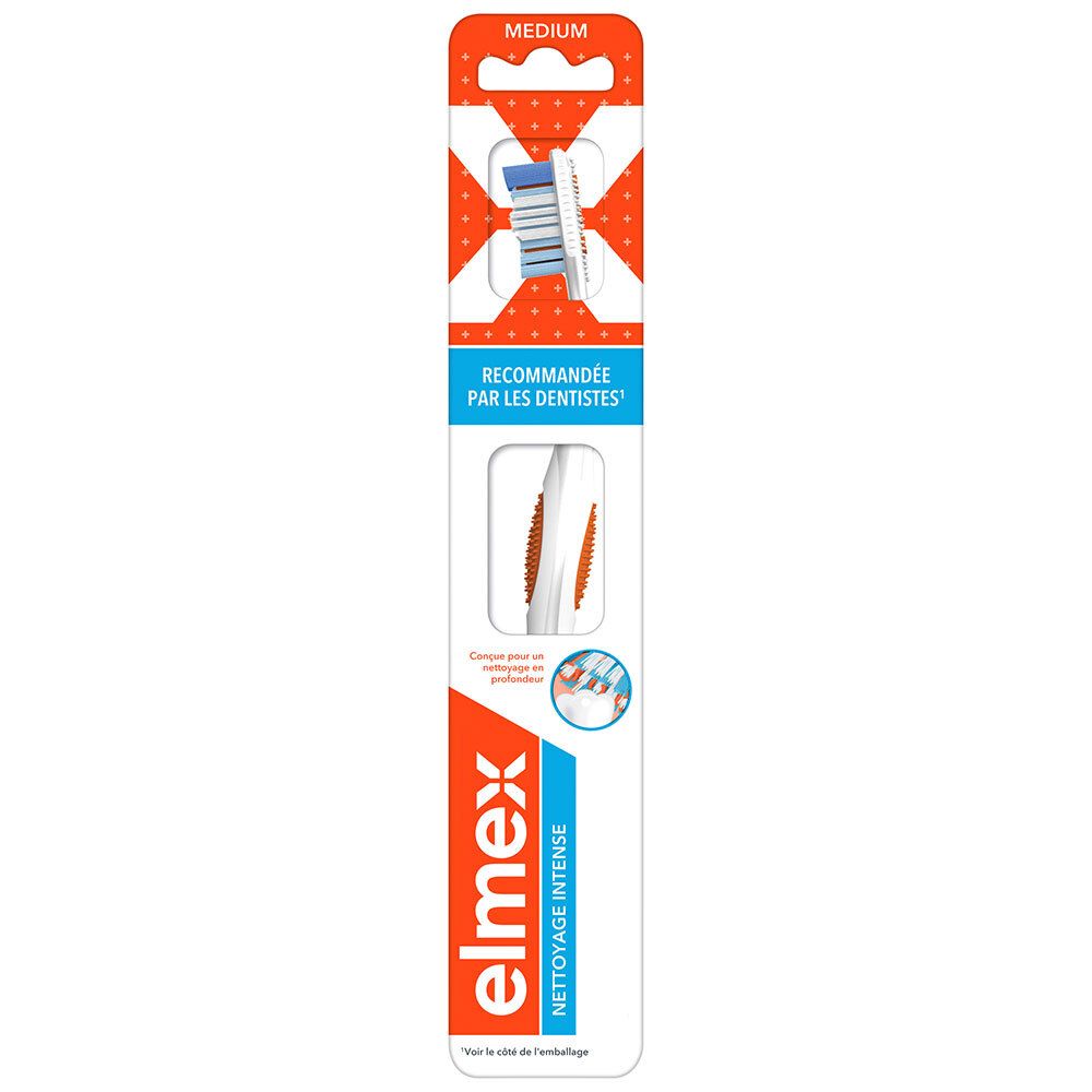 Zahnbürste in Verpackung. Orange-weißes Design. "ELMEX"-Logo. "RECOMMANDÉE PAR LES DENTISTES" Text. "MEDIUM"-Kennzeichnung.