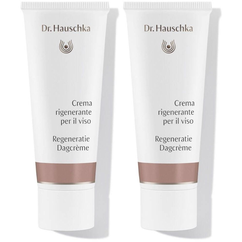 Deux tubes blancs Dr. Hauschka. Texte: Crème régénérante, Regeneratie Dagcrème. Partie inférieure marron.