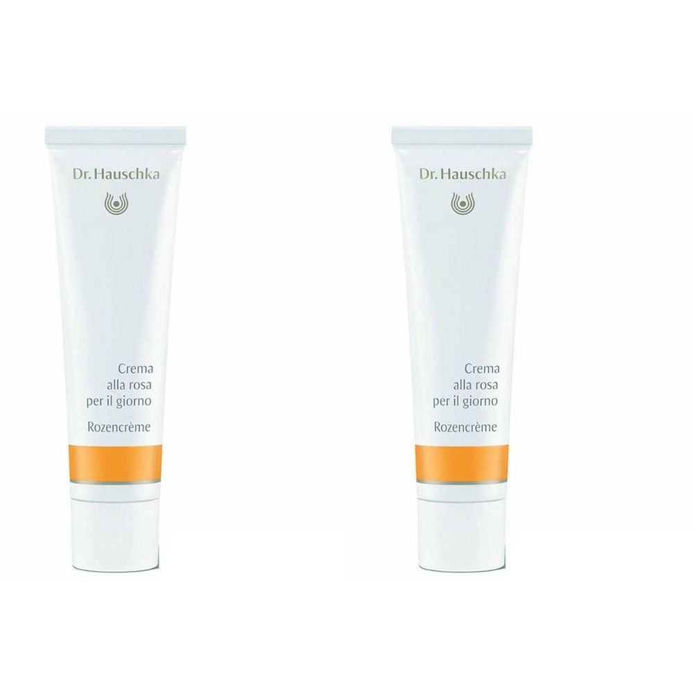 Deux tubes de crème blancs avec une bande orange. Inscription: Dr. Hauschka, Crema alla rosa per il giorno, Rozencrème.
