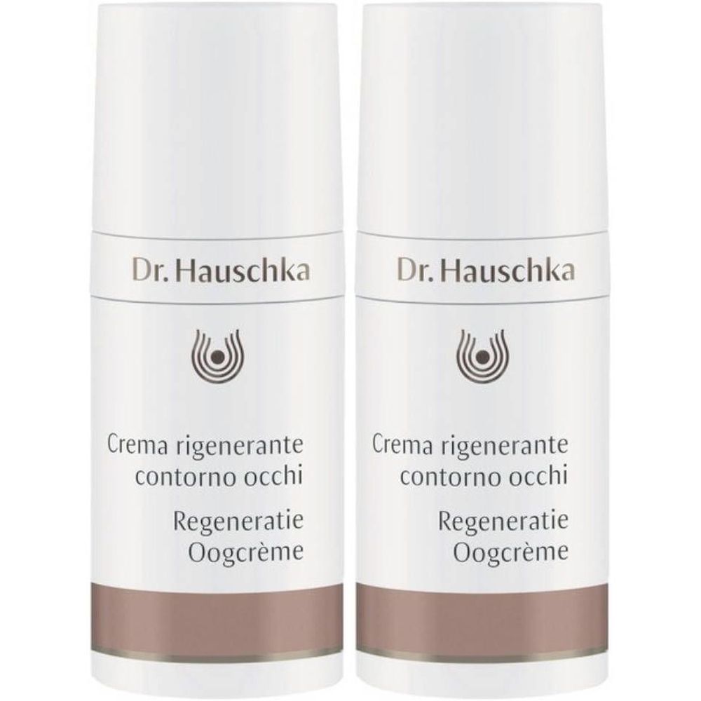 Zwei weiße Cremetuben mit braunem Boden. Aufschrift: Dr. Hauschka, Crema rigenerante contorno occhi, Regeneratie Oogcrème.