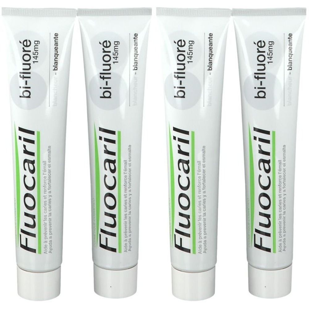 Quatre tubes de dentifrice. Chaque tube porte l'inscription "Fluocaril bi-fluoré 145mg". L'emballage est blanc avec des accents verts et bleus.
