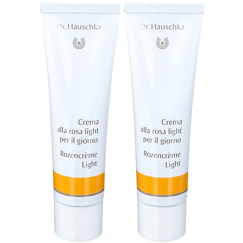 Zwei Tuben Creme. Weiß, mit gelbem Streifen und Schriftzug. Marke: Dr. Hauschka. Text: Crème de Jour Légère à la Rose.