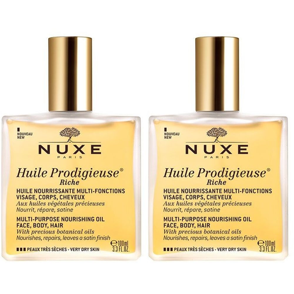 Deux flacons carrés de Nuxe Huile Prodigieuse Riche. Bouchon doré, liquide jaune. Texte : Multi-Purpose Nourishing Oil.