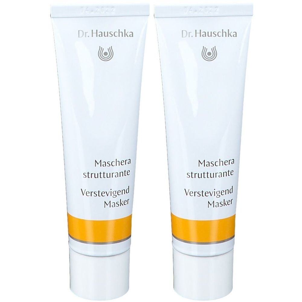 Zwei weiße Tuben mit gelbem Streifen. Aufschrift: Dr. Hauschka, Maschera strutturante, Verstevigend Masker.
