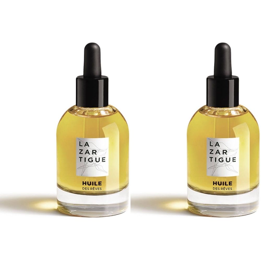 Deux flacons de LAZARTIGUE TRAUM-ÖL. Flacons en verre avec bouchon noir et pipette. Étiquette avec nom de la marque et nom du produit.