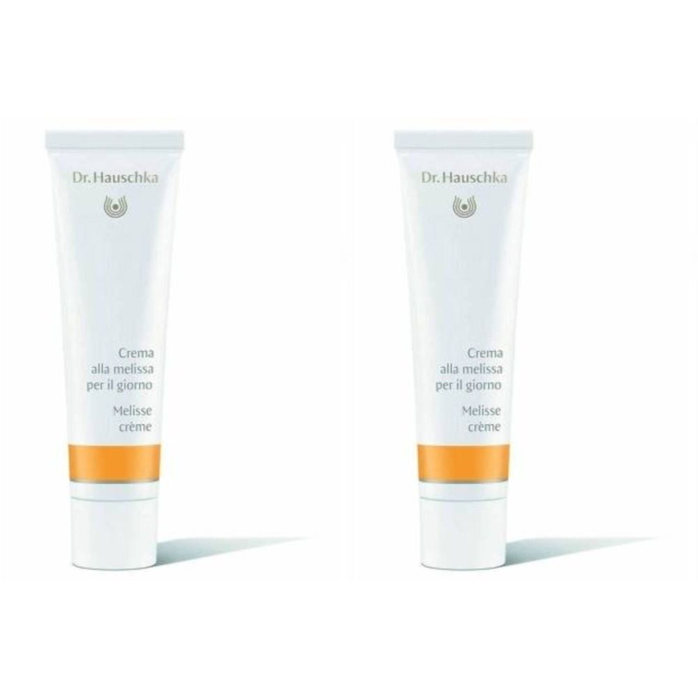 Deux tubes de Crème à la Mélisse. Blanc, avec bande orange. Inscription : Dr. Hauschka, Crema alla melissa, Melisse crème.