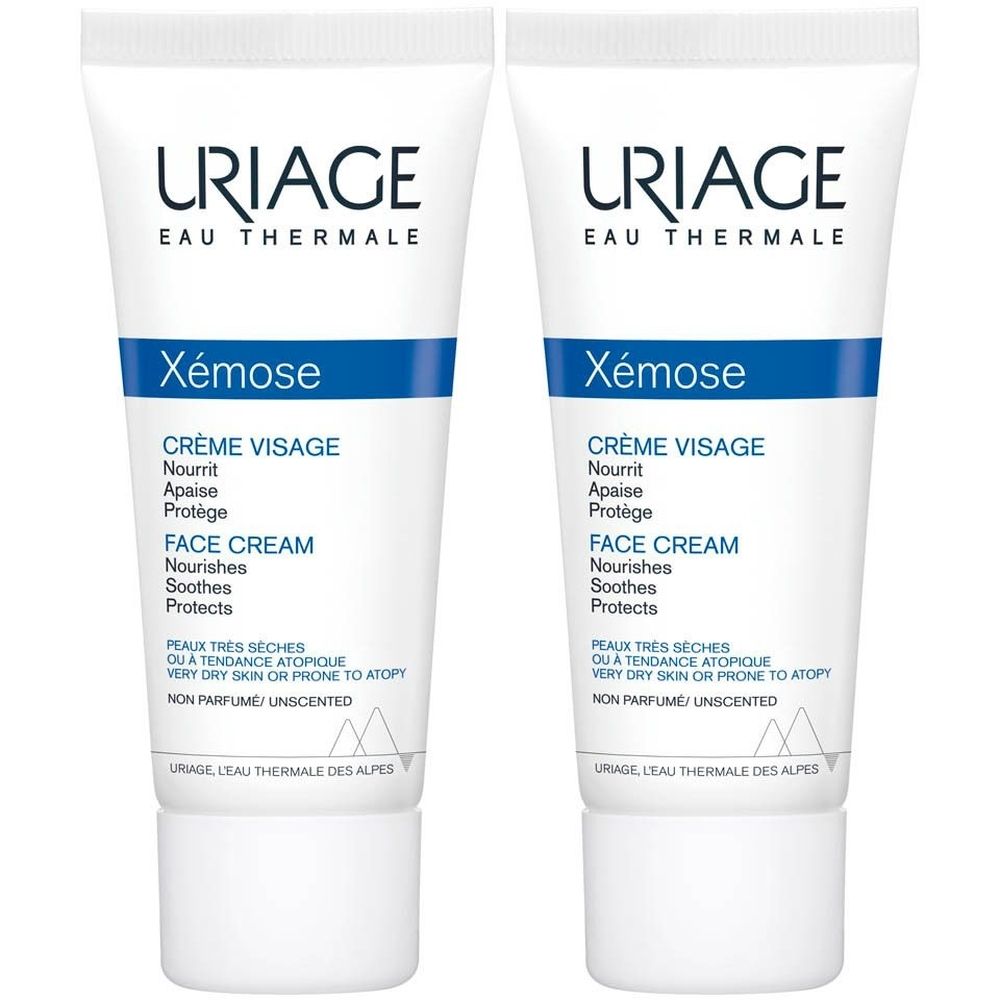 Zwei Tuben Uriage Xémose Crème Visage. Weiße Tuben mit blauen Streifen und Schriftzügen. Text: Crème Visage, Face Cream.