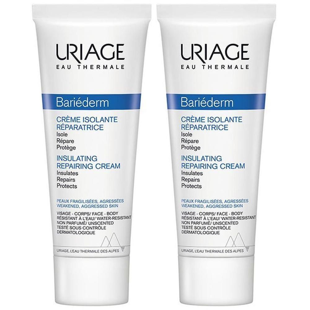 Deux tubes de crème réparatrice Uriage Bariéderm. Tubes blancs avec texte bleu. Texte: Crème Isolante Réparatrice.