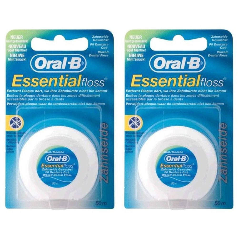Zwei Packungen Oral-B Essentialfloss Zahnseide. Weiße Spulen in Plastikverpackung. Text: Essentialfloss, 50m.