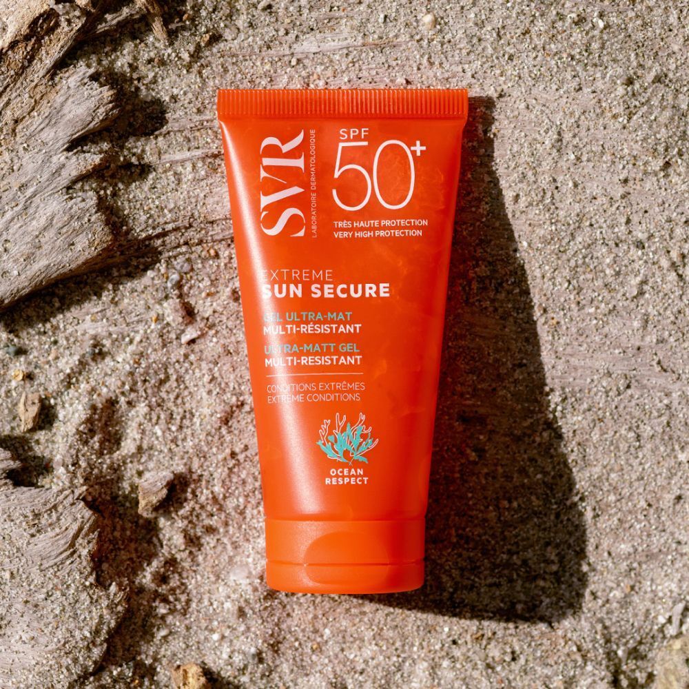 Main tenant un tube de SVR Sun Secure Extreme SPF 50+. Tube orange avec texte blanc. Inscription : Extreme Sun Secure, Gel Ultra-Mat.