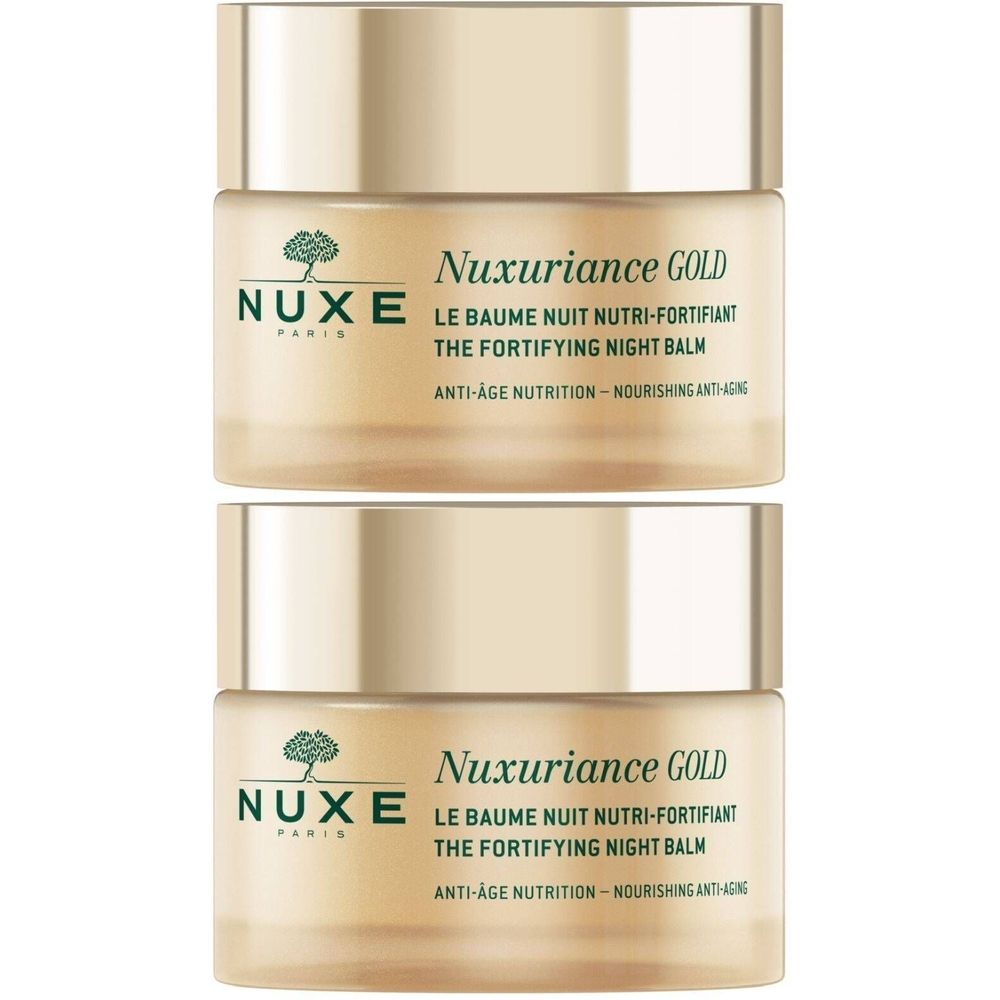 Zwei goldfarbene Tiegel. Aufschrift: Nuxe, Nuxuriance Gold, Le Baume Nuit Nutri-Fortifiant, The Fortifying Night Balm.