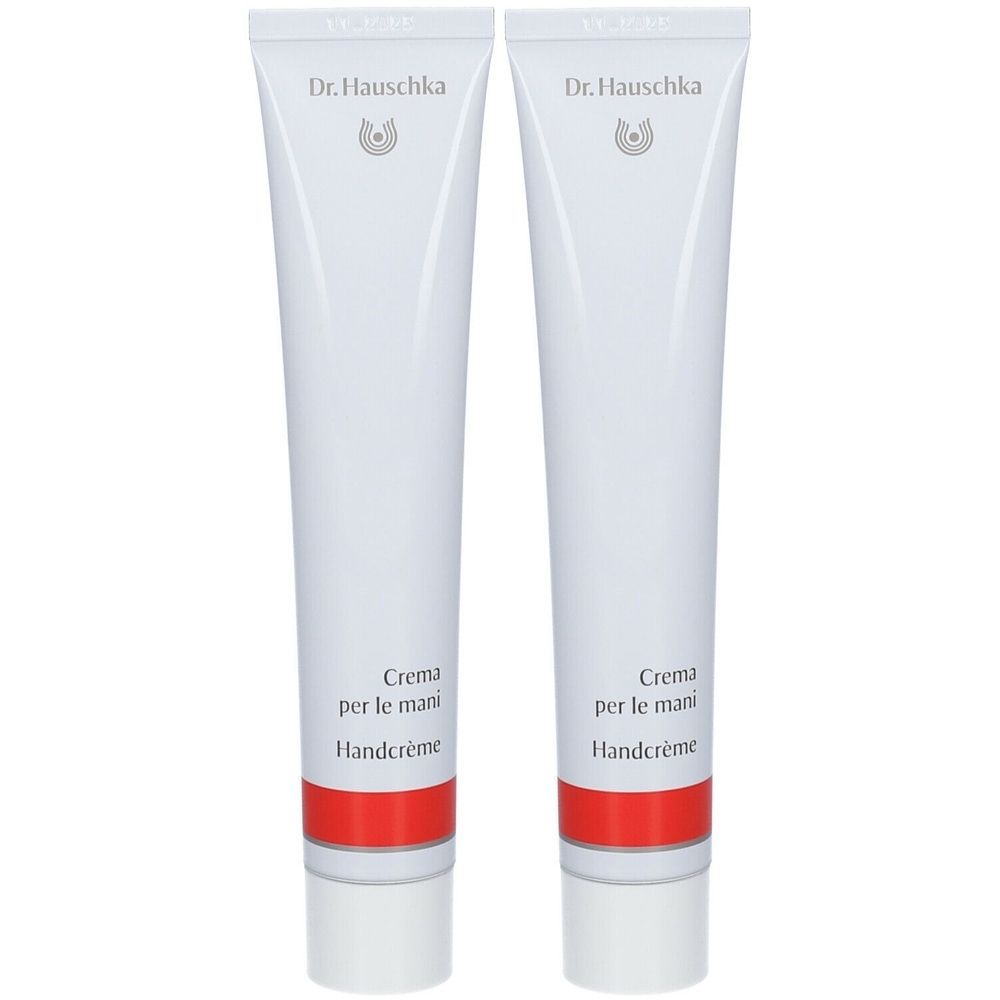 Zwei weiße Tuben mit rotem Streifen. Aufschrift: Dr. Hauschka, Crème pour les Mains, Handcrème.