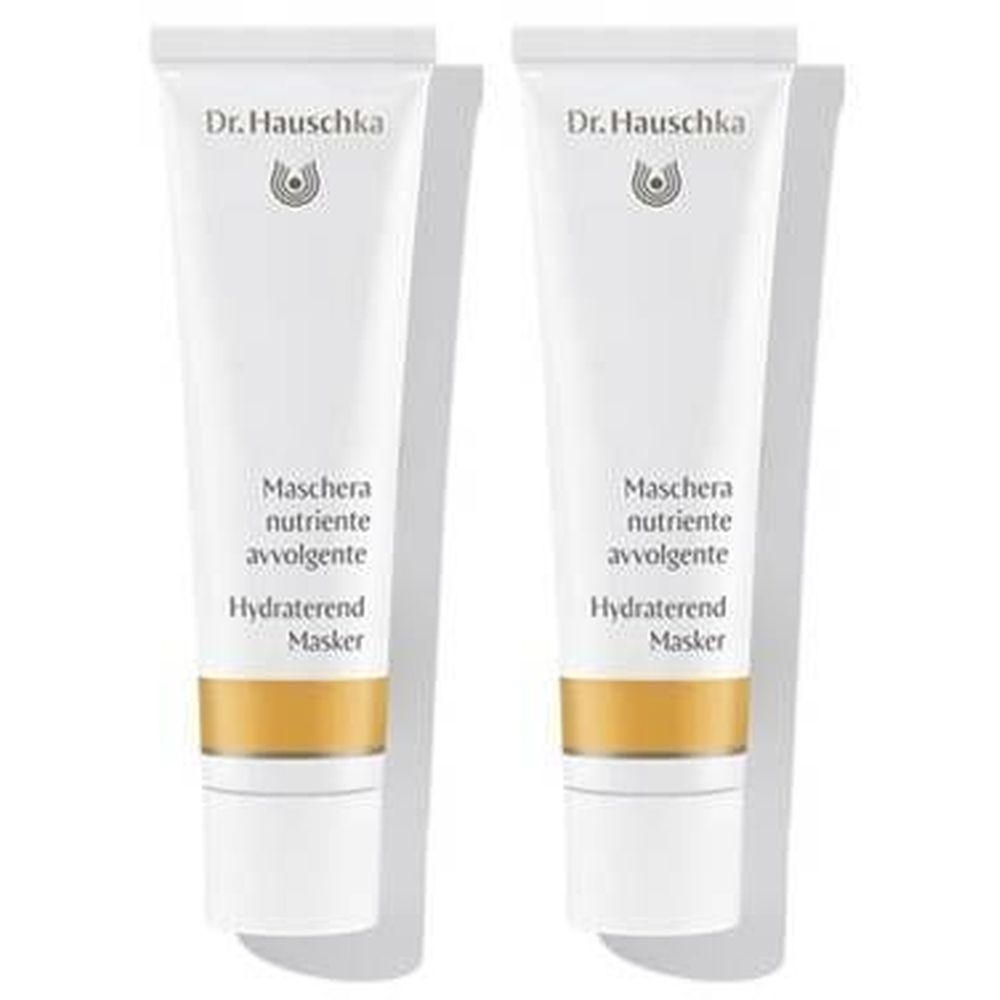 Zwei Tuben mit weißem Hintergrund. Auf jeder Tube steht "Dr. Hauschka" und Produktbezeichnungen in mehreren Sprachen.