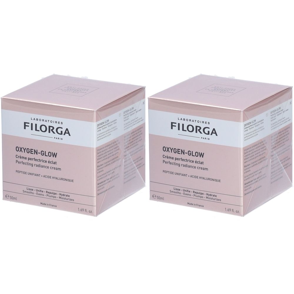 Zwei quadratische Kartons. Aufschrift: FILORGA, OXYGEN-GLOW Crème perfectrice éclat, Perfecting radiance cream. Rosa und weiß.