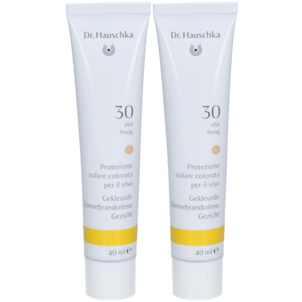 Zwei Tuben Dr. Hauschka Sonnencreme mit SPF 30. Weiße Tuben mit gelbem Streifen und Produktbezeichnungen in mehreren Sprachen.