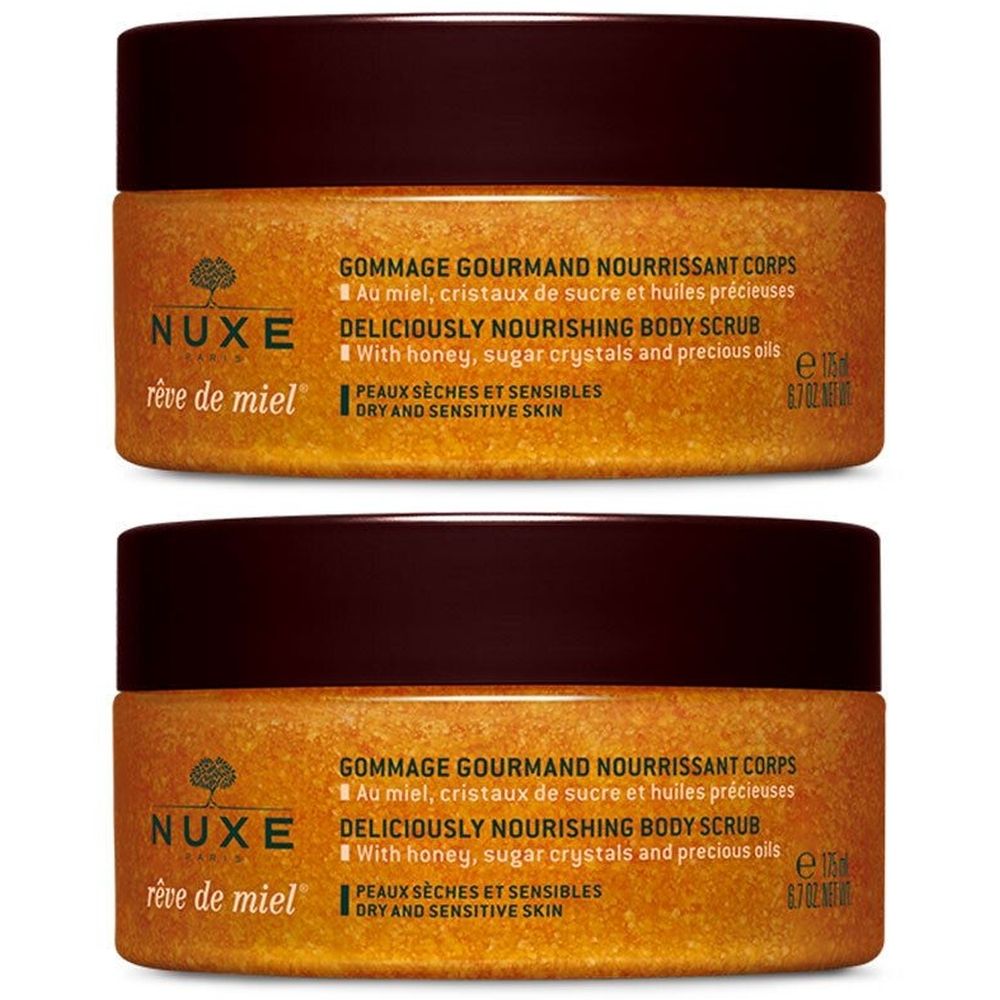 Zwei Tiegel Nuxe Rêve de miel® Gommage corps nourrissant. Brauner Deckel, goldfarbener Inhalt, Produktbezeichnung und Schrift.