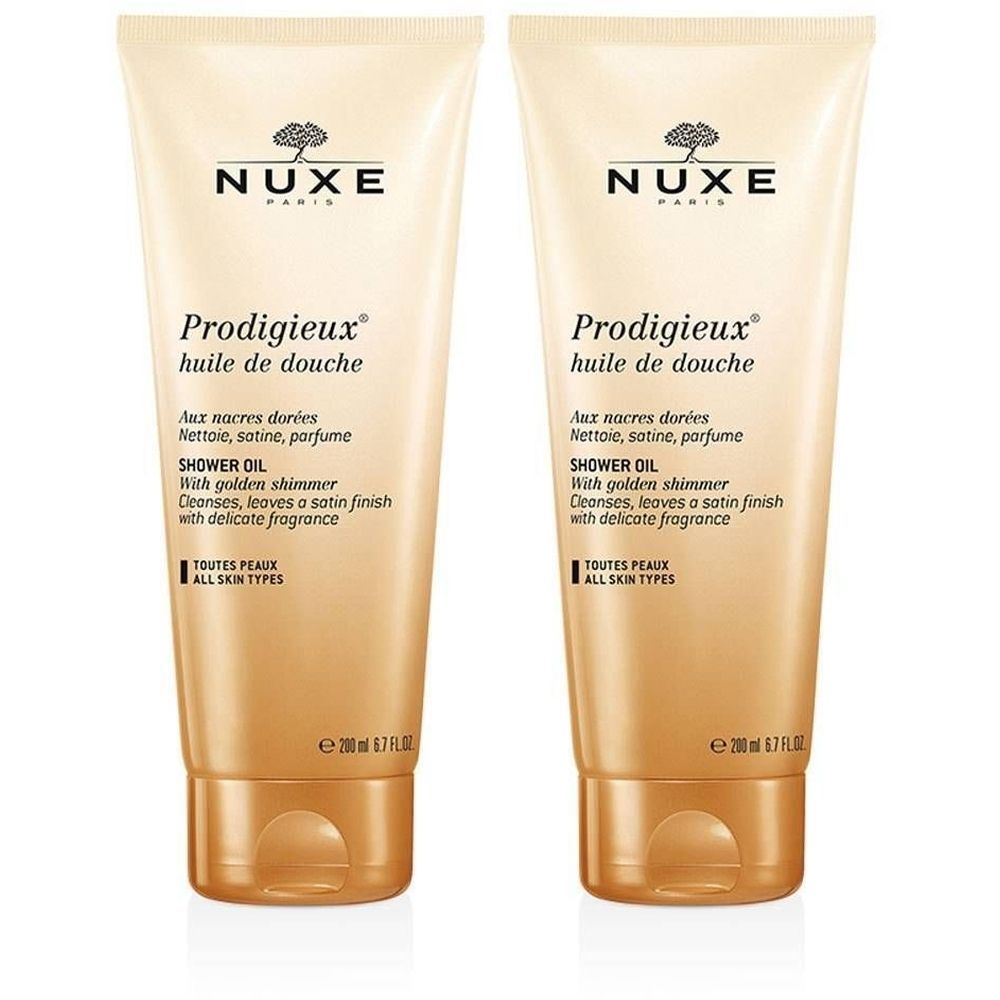 Deux tubes de Nuxe Prodigieux Huile de Douche. Couleur beige doré, texte et nom du produit. Contient 200 ml.