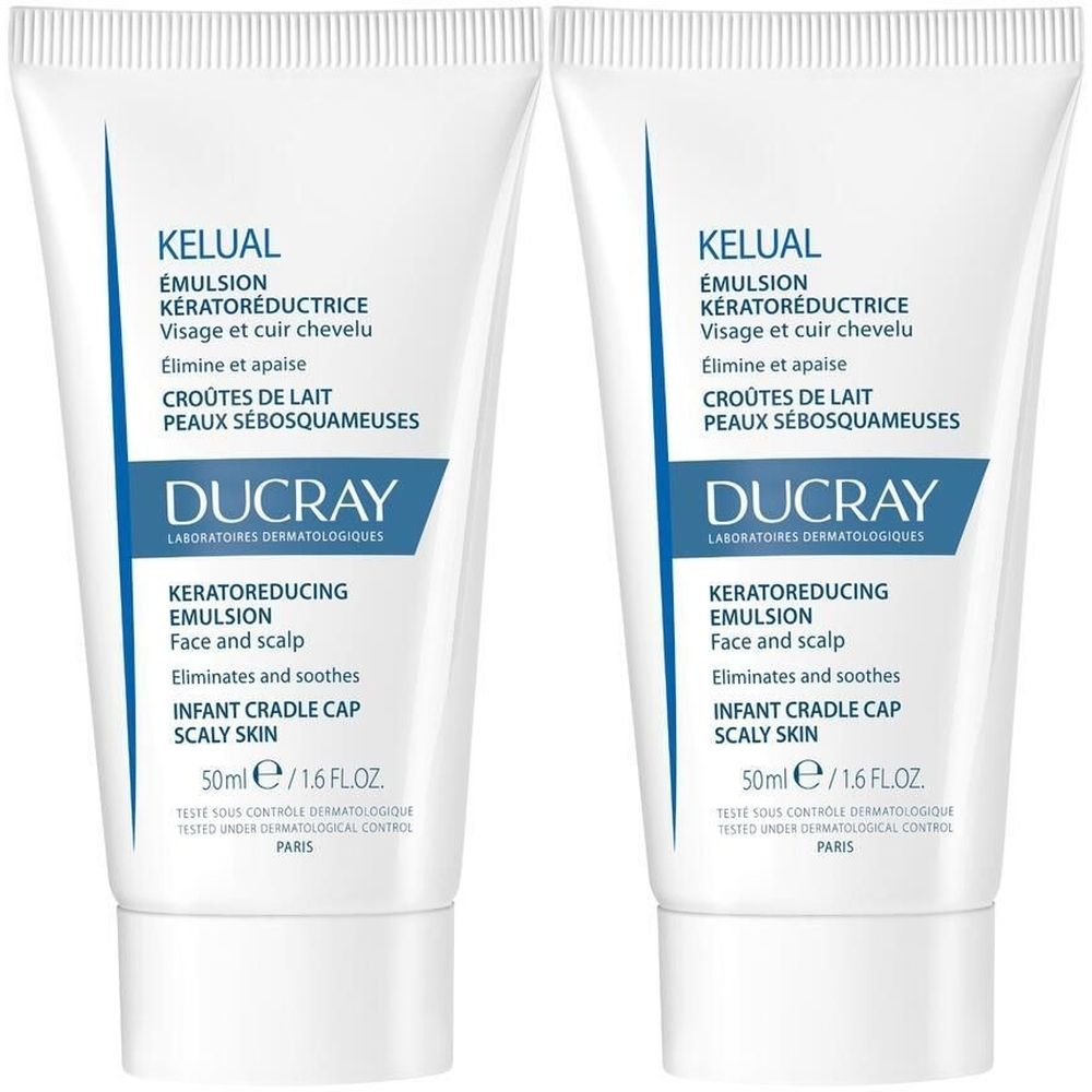 Deux tubes de DUCRAY KELUAL Emulsion. Tubes blancs avec des accents bleus et des informations sur le produit. Texte : Kératoréductrice, Face and scalp.
