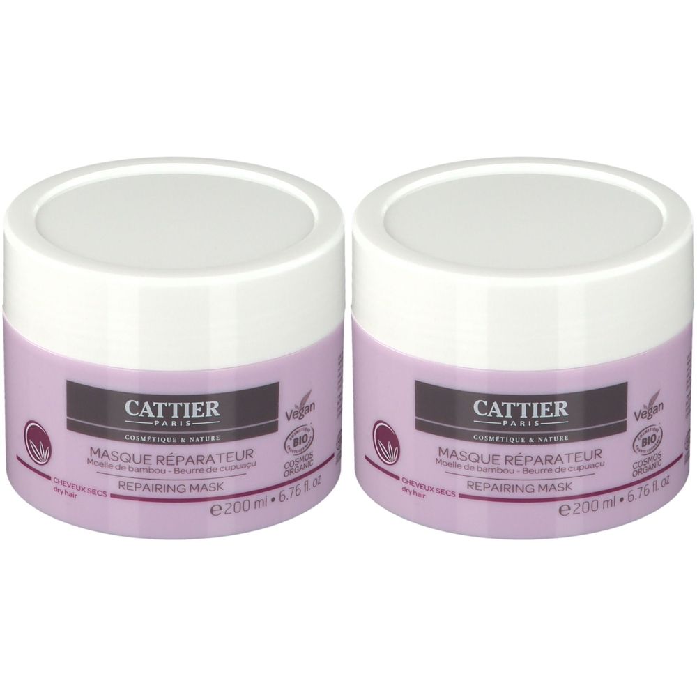Deux pots ronds violets avec couvercles blancs. Inscription: CATTIER PARIS, MASQUE RÉPARATEUR, REPAIRING MASK. Logo vegan.