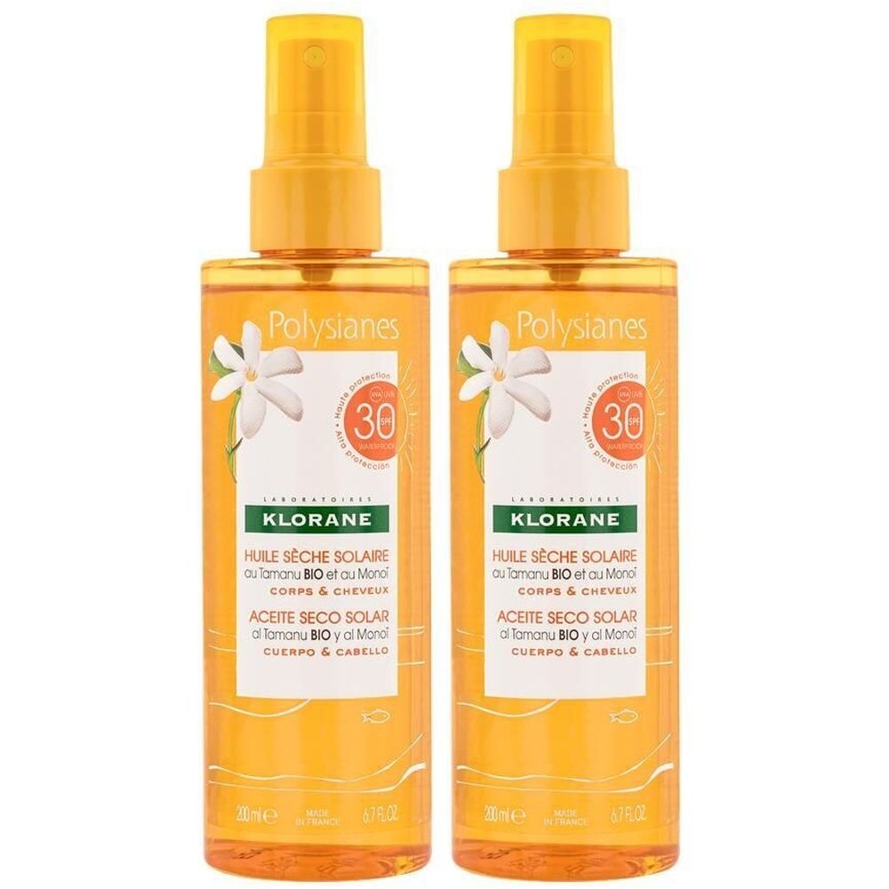 Zwei Sprühflaschen mit gelber Flüssigkeit. Aufschrift: KLORANE, Huile Sèche Solaire SPF30. Mit Blumen- und Sonnenschutzsymbolen.