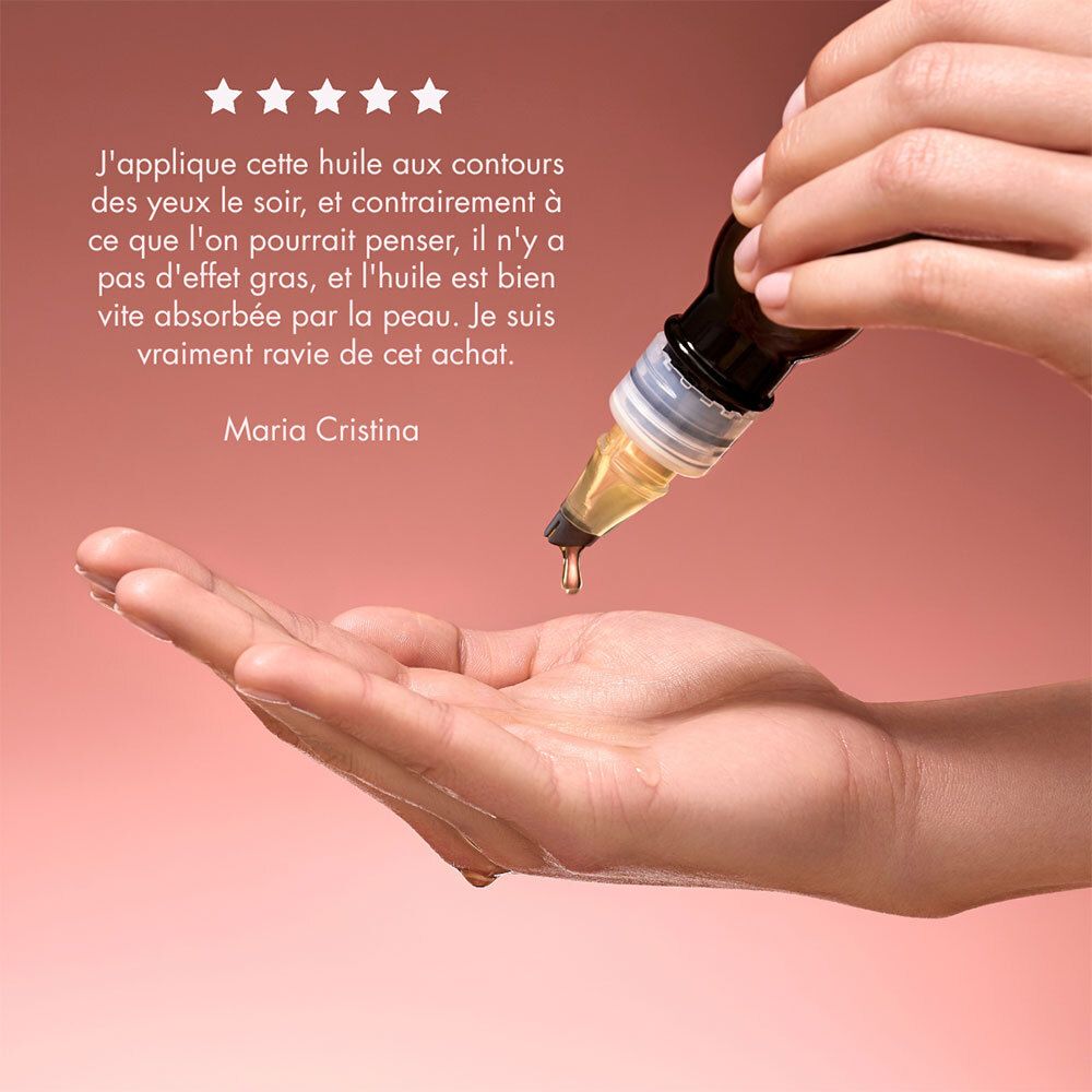 Öl tropft aus dem Applikator. Text: Maria Cristina. Rosa Hintergrund.