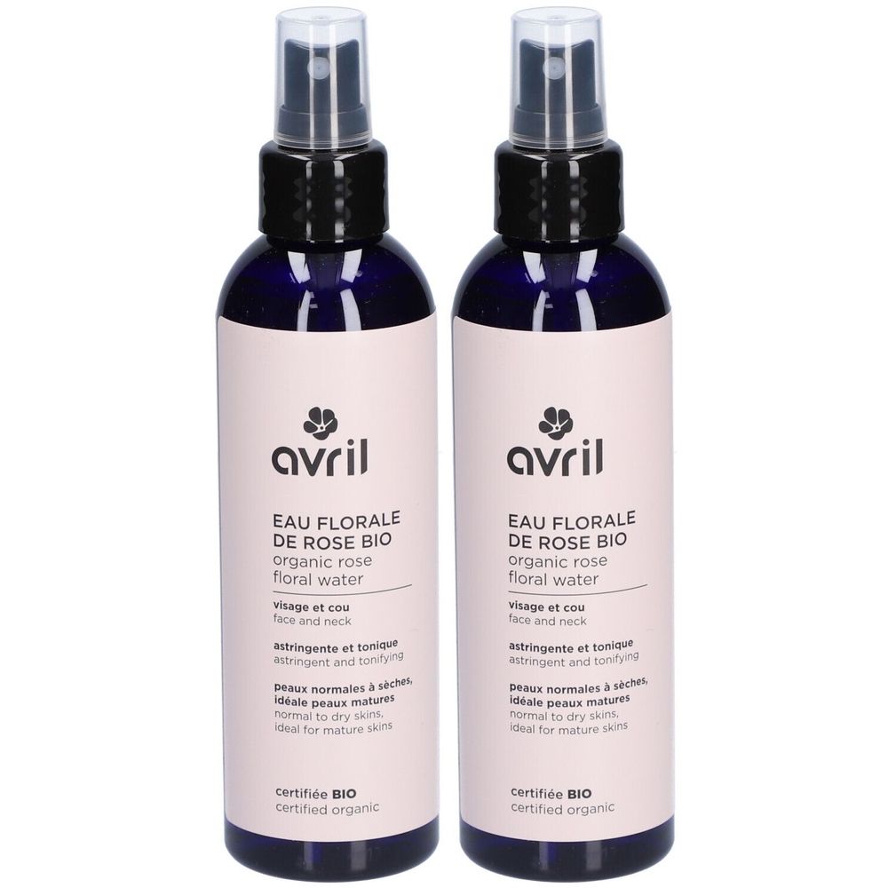 Deux flacons d'Avril Eau Florale de Rose. Flacons en verre bleu avec vaporisateur. Étiquette avec informations et certification bio.