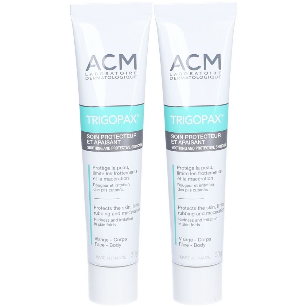 Zwei Tuben ACM Trigopax. Weiße Tuben mit türkisfarbenem Band. Aufschrift: Soin protecteur et apaisant. Für Gesicht und Körper.