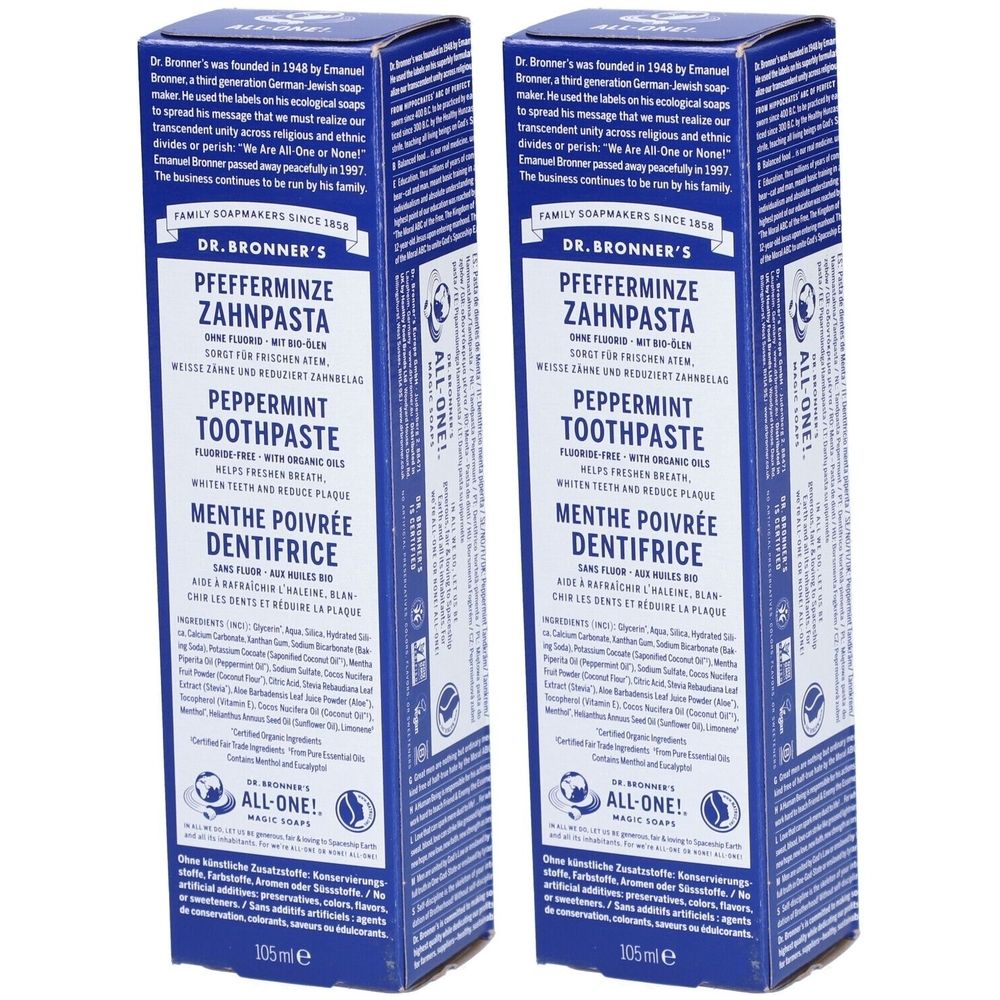 Zwei blaue Schachteln mit Aufschrift "Pfefferminze Zahnpasta". Text in Deutsch, Englisch und Französisch. Marke: DR. BRONNER'S.