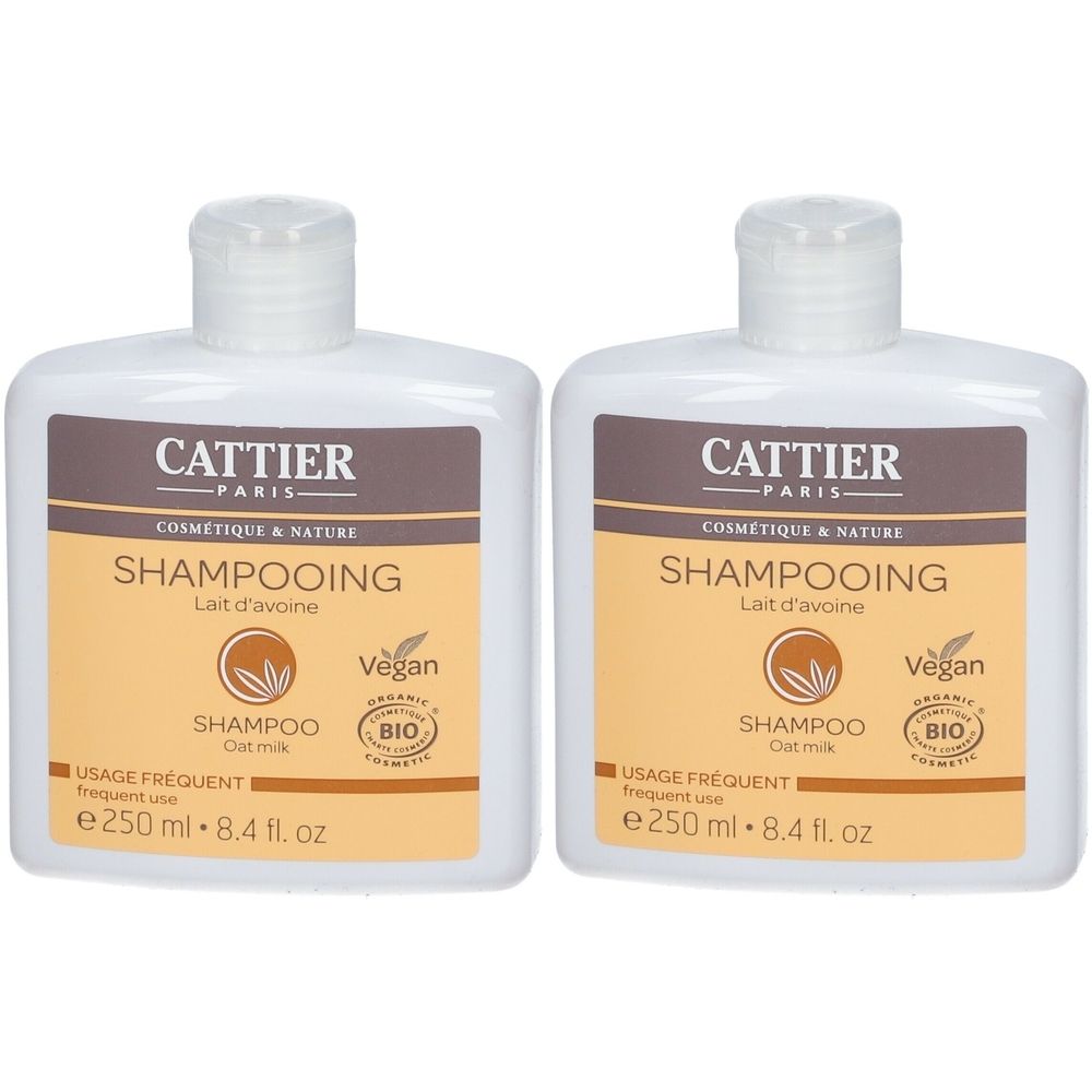 Deux flacons blancs avec étiquettes marron. Inscription: CATTIER PARIS, Shampooing, Lait d'avoine, Vegan, Bio.