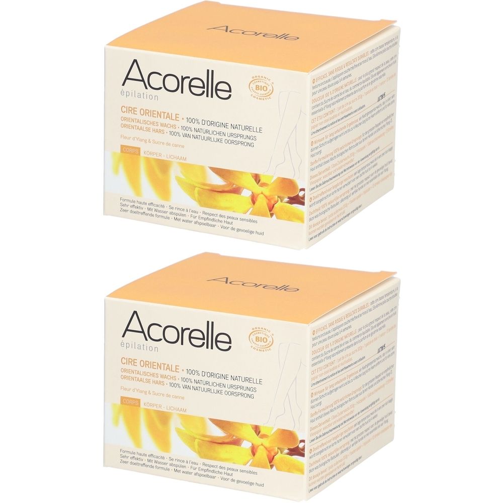 Deux boîtes carrées avec informations produit. Inscription : Acorelle Cire Orientale. Emballage jaune et blanc avec motif floral.