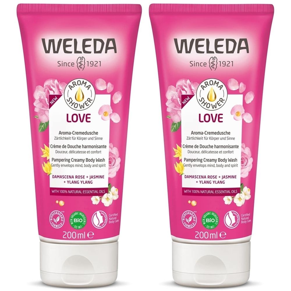 Deux tubes de crème rose. Inscription: WELEDA, LOVE, Aroma-Cremedusche, 200ml. Avec label bio.