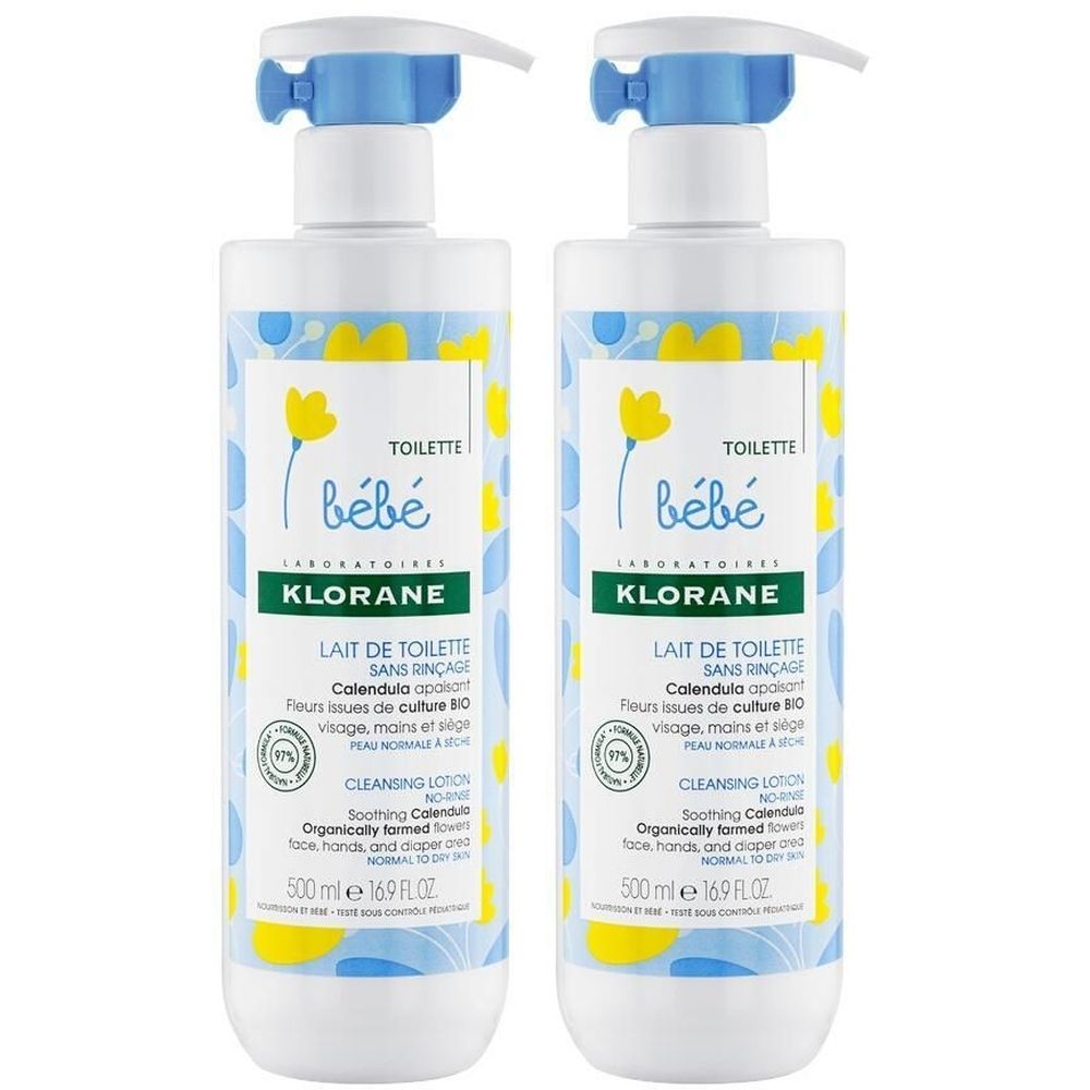 Deux flacons de Lait de Toilette Klorane Bébé. Flacons blancs et bleus avec fleurs jaunes. Avec pompe.