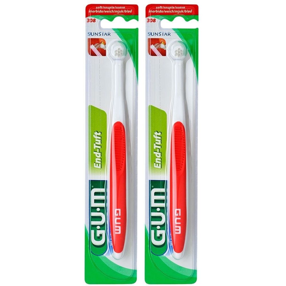 Zwei Zahnbürsten in Verpackung. Weiße Borsten, roter Griff, grüne und weiße Verpackung. Marke G.U.M, Modell End-Tuft.