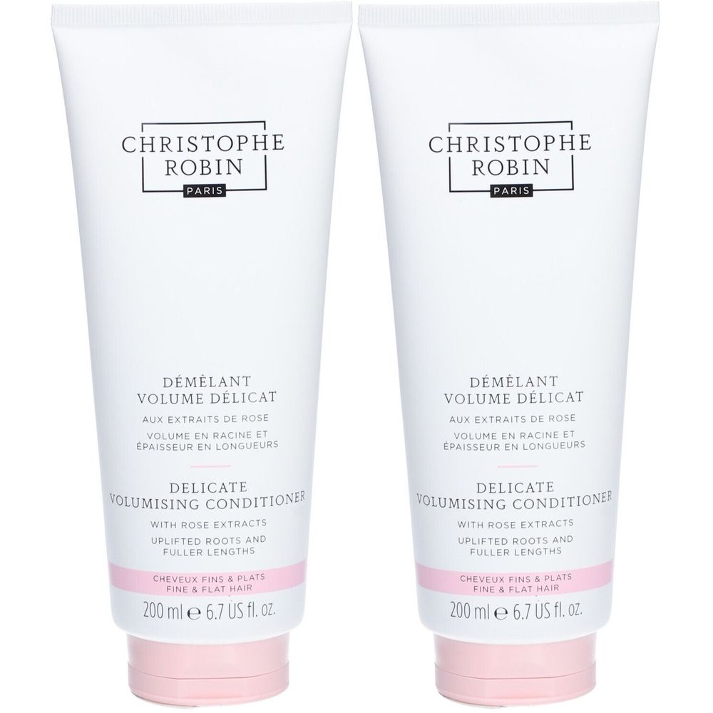 Deux tubes blancs avec texte. Marque: CHRISTOPHE ROBIN. Produit: DÉMÊLANT VOLUME DÉLICAT. Bouchon rose.