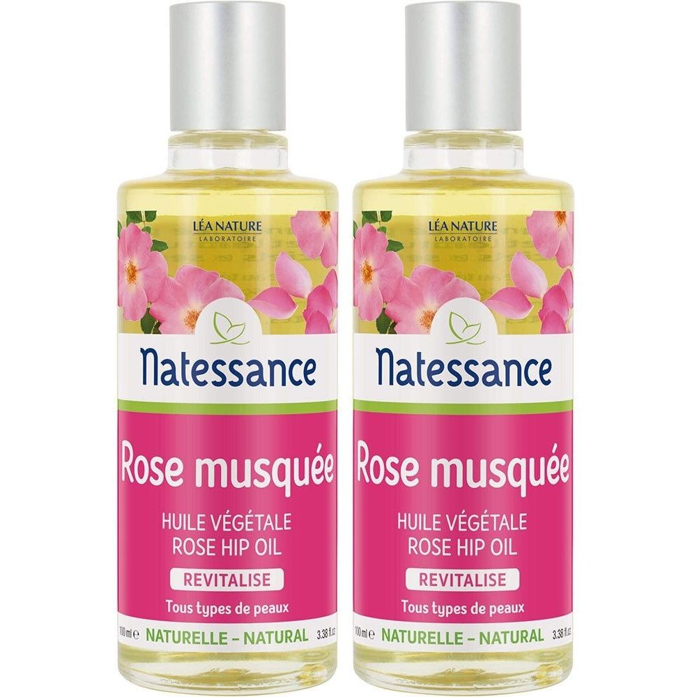 Deux flacons de huile. Étiquettes: Natessance Rose musquée, HUILE VÉGÉTALE ROSE HIP OIL, REVITALISE. Décor floral rose.