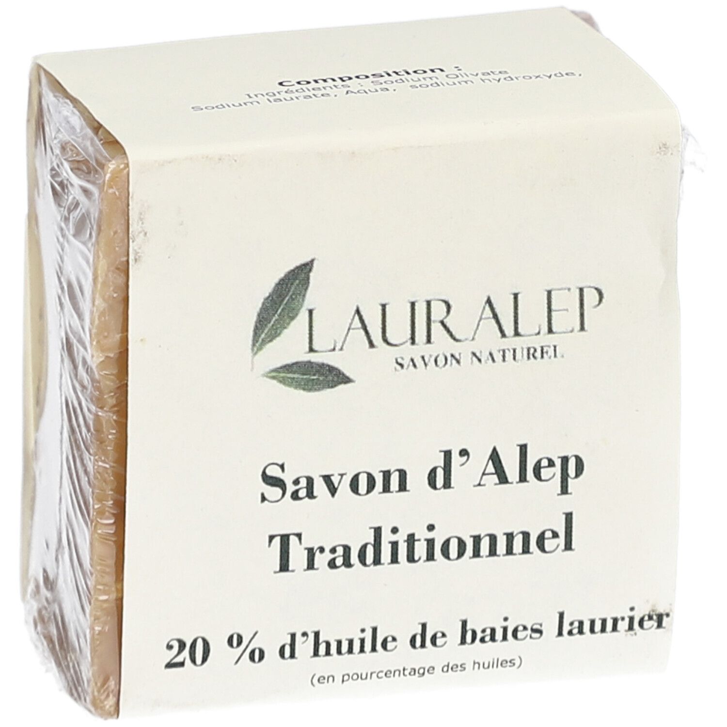 Bloc de savon carré, emballé dans du papier et du film plastique. Inscription : LAURALEP, Savon d'Alep Traditionnel, 20% huile de baies laurier.