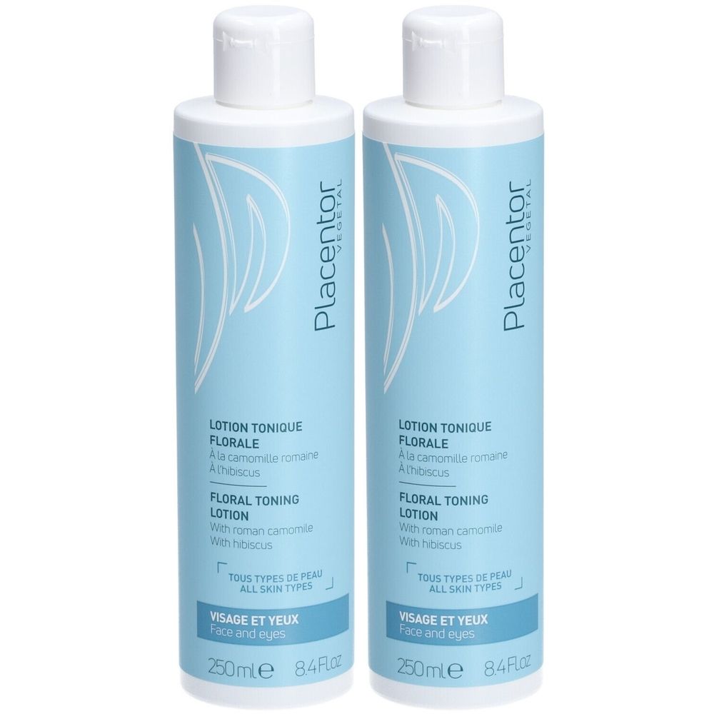 Deux flacons de Placentor VEGETAL LOTION TONIQUE FLORALE. Flacons bleu clair avec bouchon blanc. Inscription: FLORAL TONING LOTION, pour tous types de peau.