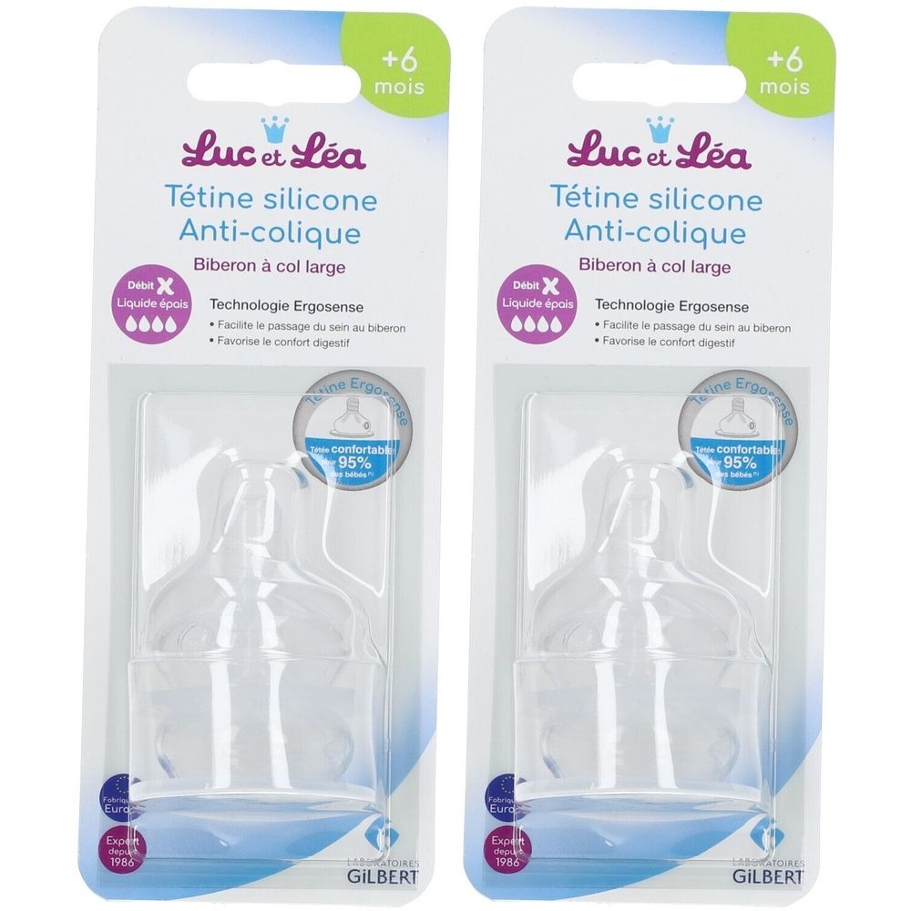 Deux tétines en silicone transparentes, emballées. Inscription: Luc et Léa, Anti-colique, +6 mois. Marque Gilbert.