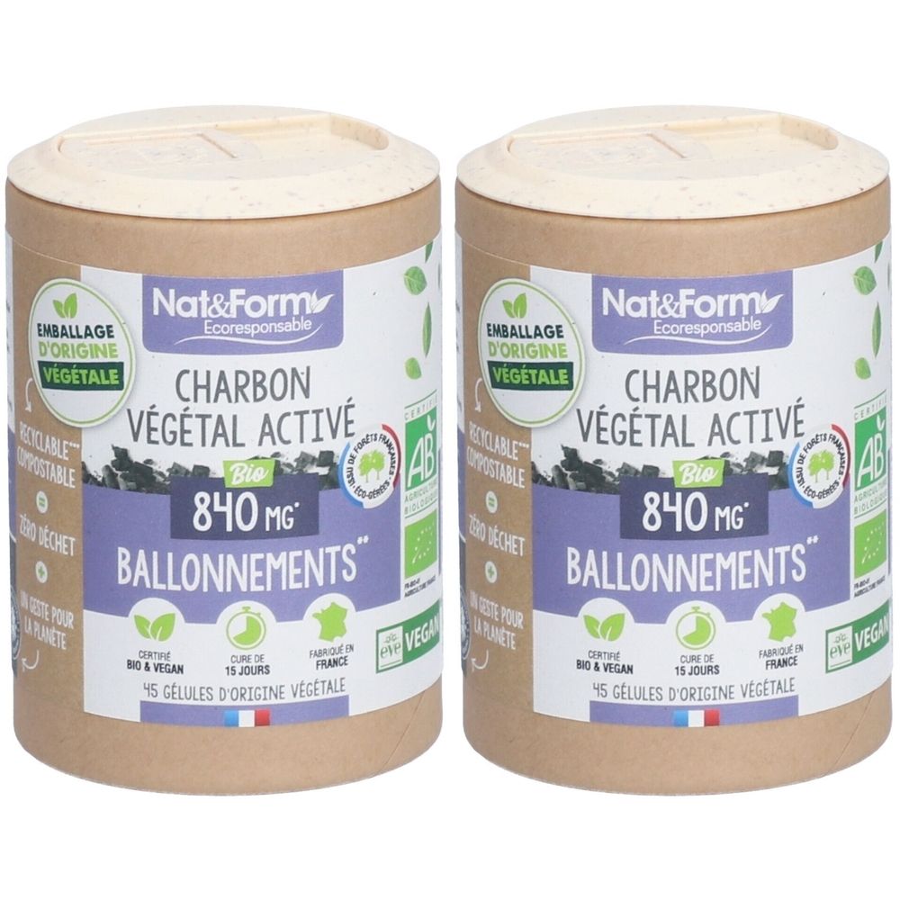 Deux boîtes cylindriques avec couvercle. Inscription: Charbon Végétal Activé, 840 mg, Ballonnement. Emballage d'origine végétale.