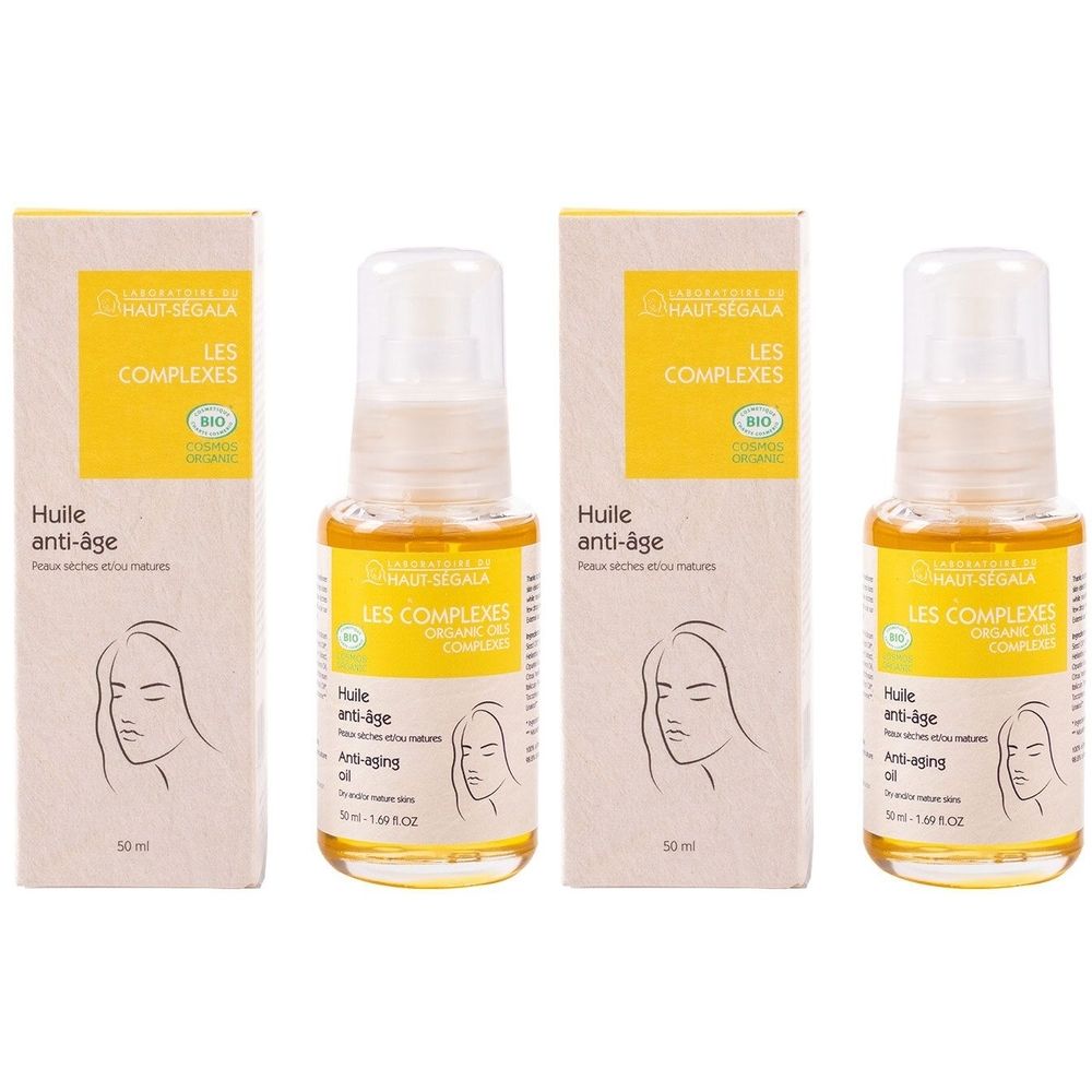 Mehrere Flaschen und Verpackungen. Aufschrift: LES COMPLEXES, Huile anti-âge. Bio-Zertifizierung. Flaschen mit Sprühkopf.