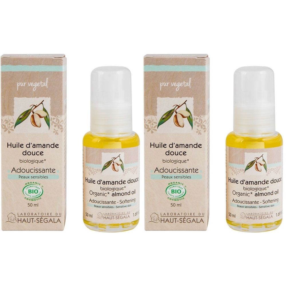 Vier Flaschen und Kartons mit Produktetiketten. Aufschrift: Huile d'amande douce biologique, Adoucissante, Peaux sensibles. BIO-Siegel.