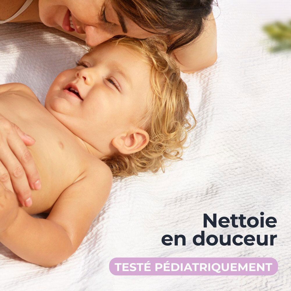 Mutter und Baby auf einem Handtuch. Text: Nettoie en douceur, Testé pédiatriquement.
