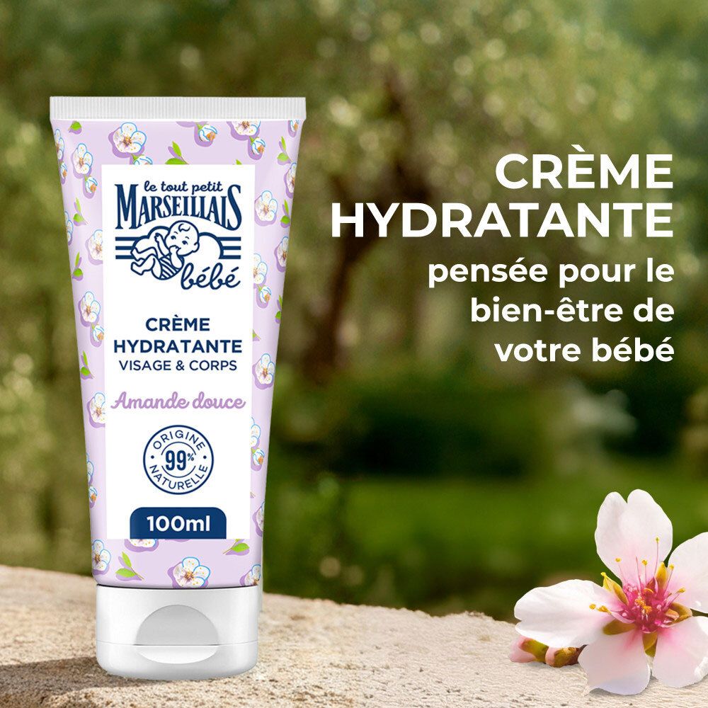 Tube de crème floral. Texte : Crème Hydratante, Amande Douce. Fond : nature floue.