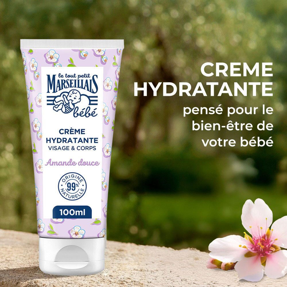 Tube de crème floral. Texte : Crème Hydratante, Amande Douce. Fond : nature floue.