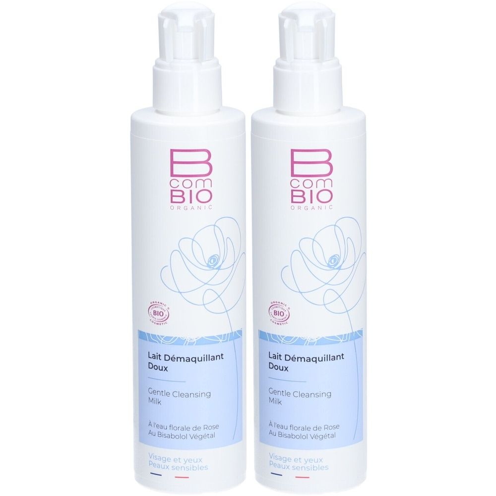 Zwei Flaschen B COM BIO ORGANIC Milde Reinigungsmilch mit Pumpverschluss. Schlichtes Design mit Blumenmotiv.