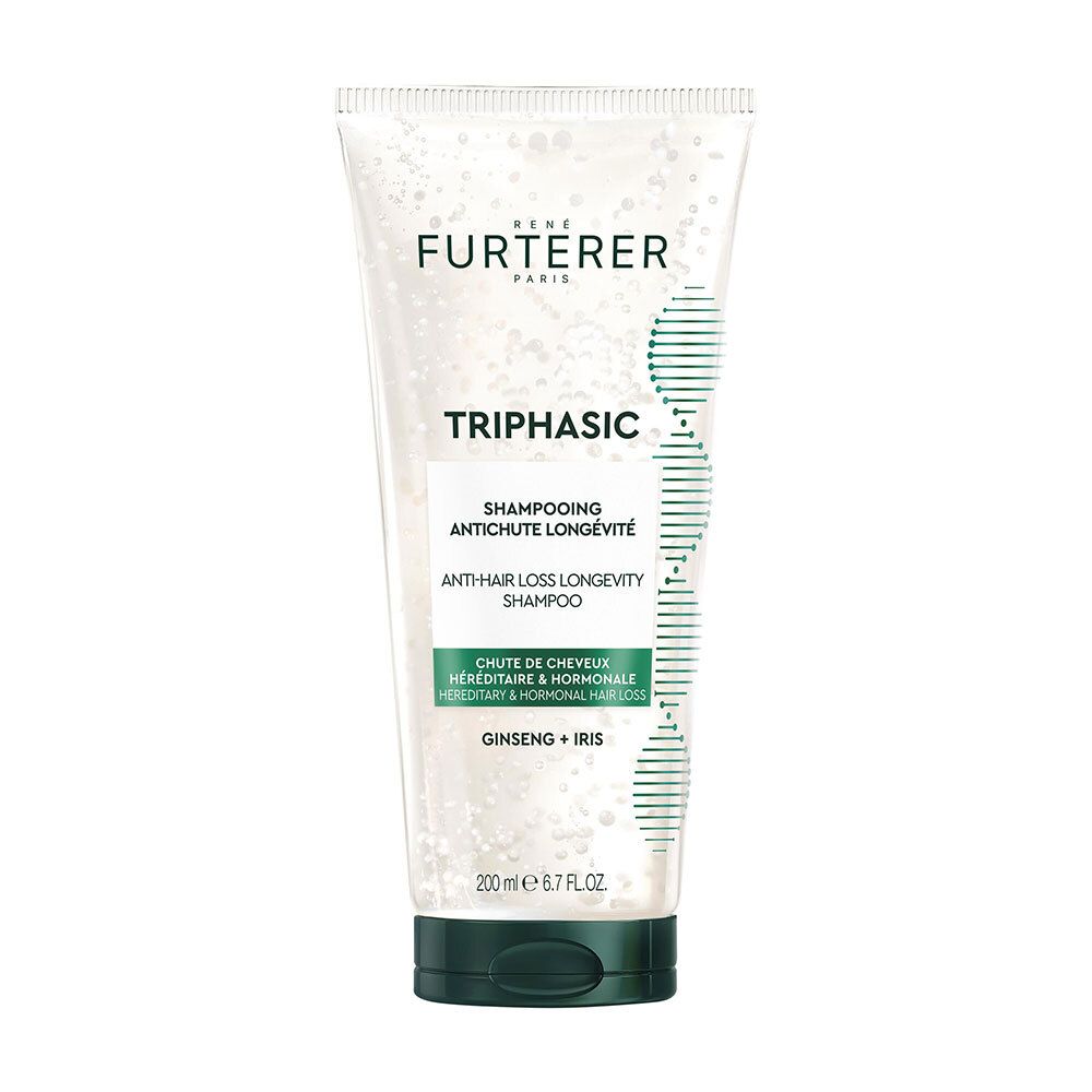 Tube transparent de shampooing Furterer Triphasic. Inscription: Anti-chute, longévité. Couleurs vert et blanc.