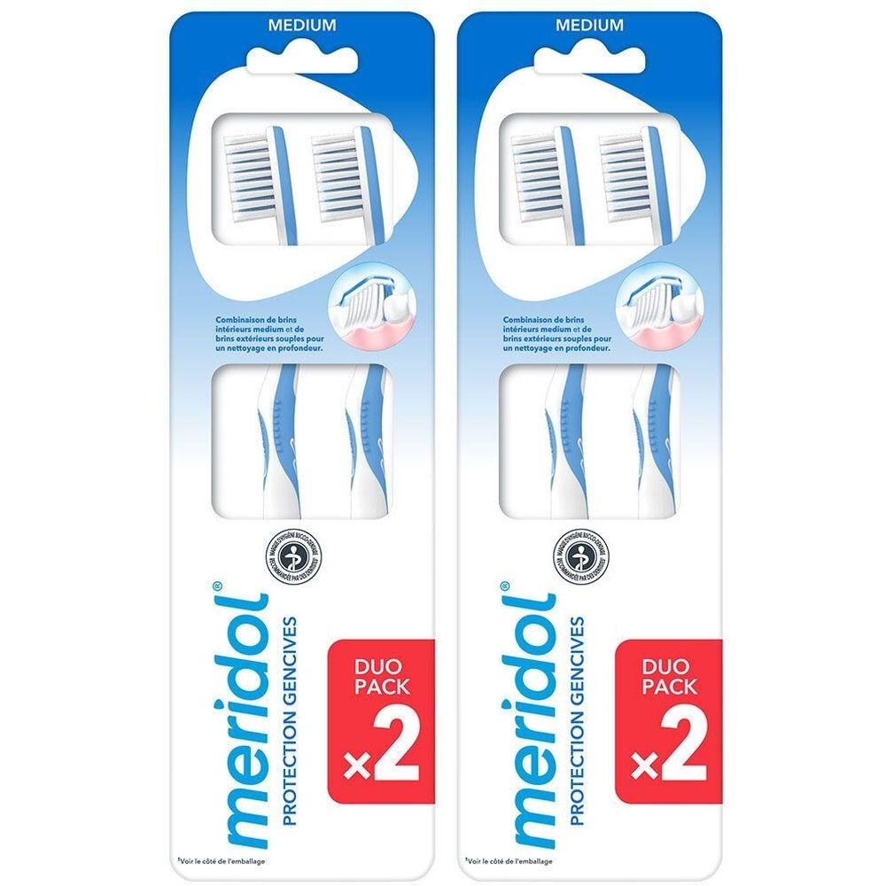 Deux packs doubles de brosses à dents. Brosses à dents bleues et blanches dans un emballage. Inscription: meridol PROTECTION GENCIVES, Duo Pack x2.